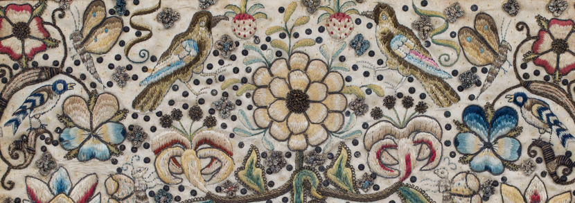Late 17th century metal thread and silk needlework panel depicting overall stylized plants, flowerheads, fruit, scrolling tendrils, birds and butterflies