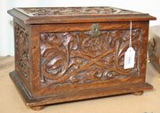 An early 20th Century oak jewellery casket, profusely carved with foliate scrolls, the front bearing the initials 'A.C.W'.