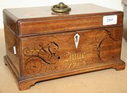 A George II mahogany tea caddy, the hinged lid later inlaid with flowers, the interior fitted with two lidded containers, the front with inlaid and penwork decoration, on bracket feet, length approx 27.5cm.