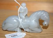 A Chinese grey jade carving, possibly 19th Century, modelled as a monkey seated on the back of a recumbent horse, length approx 12cm, together with a grey jade paperknife with pierced bird handle, length approx 21.5cm.