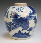 A Chinese blue and white porcelain ginger jar, mid-17th Century, the stout ovoid body painted with mythical beasts amongst plantains, height approx 24cm.