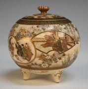A Japanese Satsuma koro and cover by Kinkozan, Meiji period, the globular body painted and gilt with variously shaped figural panels against a ground of flowers, on tripod feet, signed 'Kinkozan zo' in gilt to base, height approx 8cm, together with another Satsuma koro and cover painted with a landscape (repaired and faults).