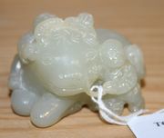 A Chinese celadon jade carved figure group, probably early 20th Century, modelled as two boys and a recumbent water buffalo, length approx 5.5cm.
