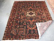 A Bakhtiari rug, North-west Persia, modern, the blue field with a rectangular compartment, all supported by geometric flowerheads and leaves, within a red continuous flowerhead border, approx 205cm x 157cm.