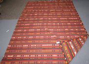 A large kelhim rug, early 20th Century, the geometric banded field with yellow and ivory details, approx 260cm x 175cm.