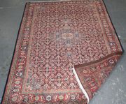 A Tabriz rug, North-west Persia, mid/late 20th Century, the ink blue herati field with a lobed medallion, within a red turtle palmette and flowerhead border, approx 206cm x 132cm.