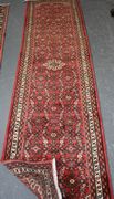A Hamadan runner, North-west Persia, modern, the red field with an overall lattice of flowering vines, within a flowerhead border, approx 290cm x 75cm.