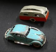 A Dinky Toys No. 30a Chrysler airflow saloon, finished in turquoise with blue wheels and white tyres (playwear, paint chips and replaced rear bumper), and a caravan, finished in grey and red (paint chips and repair).