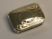 A George III silver vinaigrette of rectangular form with canted corners, the hinge lid engraved with foliage, the gilt interior with pierced grille, Birmingham 1790 by Joseph Taylor, length approx 2.3cm.
