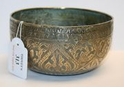 A Chinese white metal circular bowl, probably late 19th Century, embossed with scrolling foliage.