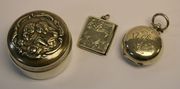 An Edwardian silver sovereign case, Chester 1901, a silver envelope stamp case, Chester 1911 and a silver circular box and cover embossed with a mother and child, Chester 1904. 