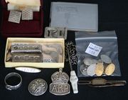 A pair of 9ct gold oval cufflinks, Birmingham 1938, a pair of silver oval cufflinks, Chester 1898, another pair of silver cuff links, two silver ingot pendants, a silver 'ARP' badge, a silver belt ring, a silver button, two silver studs and a small collection of other items.