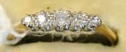 A gold, platinum and diamond set five stone ring, mounted with circular cut diamonds graduating in size to the centre stone.