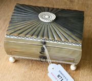 An Anglo-Indian ivory mounted horn sewing casket, 19th Century, of rectangular form, the radiating reeded hinge lid with carved ivory oval flowerhead finial, revealing a fitted compartmentalized interior, above a single frieze drawer, on turned ivory ball feet, length approx 13cm.