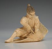 A Japanese carved ivory okimono figure group, Meiji period, in the form of a hunter killing an eagle, height approx 7cm.