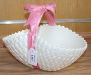 A Minton majolica basket, circa 1880, the white glazed body tied with a pink ribbon bow which forms the overhead handle, impressed marks to base with shape No. '2280' (minor faults).