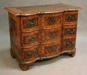 A mid-18th Century Italian walnut commode, crossbanded and with boxwood stringing, the top with star inlay, the serpentine front fitted with three long drawers, on bracket feet, width approx 119cm.