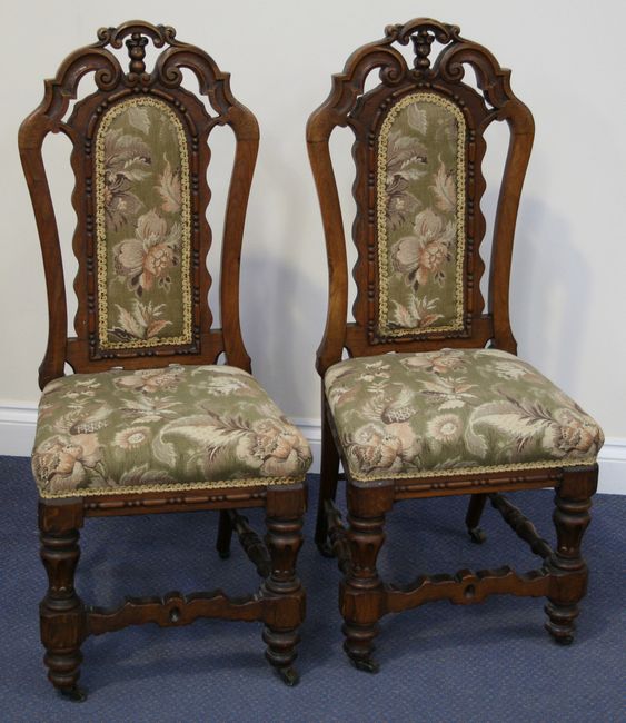 A pair of late Victorian oak dining chairs with carved and pierced frames, 
