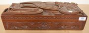 An Anglo-Indian carved hardwood box, the lid carved with a dragon.