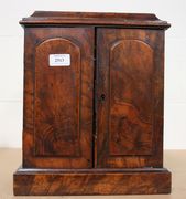 A Victorian burr walnut tabletop cabinet, fitted with a pair of panel doors revealing three drawers, on a plinth base (faults).