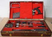 A set of mid-19th Century surgeon's instruments, including hacksaw, backsaw, three long knives marked 'Salt & Son, Bull St' (one tip broken), trepanning instruments including two trephines, trephine handle and Hey saw, scalpels, tweezers, pliers, probes, bodkins and screw tourniquet, within a fitted brass-bound mahogany case, lined with red baize, with lift-out tray, case approx 40.5cm x 22.5cm x 8cm (some instruments missing, some replacements, some corrosion and minor faults).