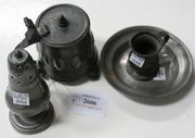 A late 18th/early 19th Century pewter lidded tankard, probably German, the slightly flared sides with engraved and embossed decoration, together with a pewter caster, a saucer and a measure.
