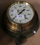 A brass cased pressure gauge and a similar smaller gauge.