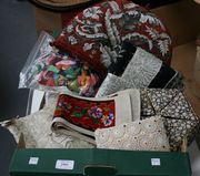 A Victorian beadwork tea cosy, decorated with grey and white foliage on a red needlework ground, together with a collection of textiles.