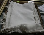 A group of four linen tablecloths and a small collection of place mats.