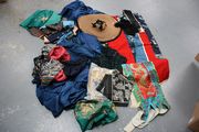 A collection of Chinese embroidery and silks, and a Mongolian leather bag.