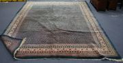 A Serabend carpet, West Persia, mid-20th Century, the blue field with overall offset rows of boteh, within an ivory border, approx 303cm x 242cm.