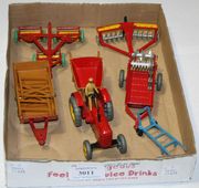 A small collection of Dinky Toys agricultural implements, including a No. 27a Massey Harris tractor, a No. 27b Halesowen farm trailer and a No. 27h disc harrow (7) (some paint chips).