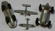 A Dinky Toys No. 23c Mercedes racing car, a No. 23e Speed of the Wind racing car, a No. 62a Spitfire and a No. 70d twin engine fighter (some paint chips).