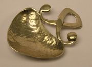 An Arts and Crafts silver caddy spoon, the heart shaped bowl with hammered decoration, applied with an entwined scrollwork handle, Birmingham 1927 by W.K. & Co.