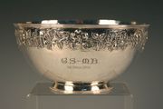 A Scottish Arts and Crafts silver circular bowl decorated in relief with a continuous band of wild roses and leaves on a hammered ground, Glasgow 1913 by J. Hall & Co, stamped 'J. Hall & Co, Manchester' to base, diameter approx 20.5cm.