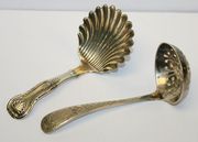 A late Victorian silver sifter spoon, the scroll handle with engraved foliate decoration, Sheffield 1900, together with a Victorian Scottish silver caddy spoon, with scallop shell bowl, Edinburgh 1864.