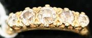 An 18ct gold and diamond set five stone ring, mounted with cushion shaped diamonds graduating in size to the centre stone, the mount with scroll pierced sides.