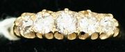 An Edwardian 18ct gold and diamond set five stone ring, mounted with cushion shaped diamonds graduating in size to the centre stone, London 1908.