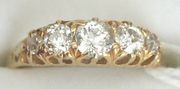 A gold and diamond set five stone ring, the diamonds graduating in size to the centre stone.