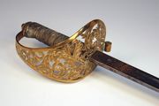 An ERVII 1857-pattern 5th Northumberland Fusiliers officer's sword by Henry Wilkinson, No. 38599, with straight dumbbell section blade, length approx 82.5cm, etched with ERVII cypher, battle honours to Khartoum, flaming grenade, etc (some light pitting), gilt brass foliate scrolled hilt with wire bound fishskin covered grip (lacking scabbard), with photocopy of page from Wilkinson's Register stating sword sold to G.L Paton [killed Gallipoli 10 Aug 1915].