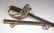 A GRV Coldstream Guards officer's sword by Wilkinson, No. 63326, with straight dumbbell section blade, length approx 82.5cm, etched with GRV cypher, battle honours to Hindenburg Line and 'H.J.L.G.' (blade heavily polished, some battle honours indistinct), plated triple bar hilt incorporating Coldstream badge, wire bound fishskin covered grip, in its plated steel scabbard, together with letter from Wilkinson Sword, stating sword sold to H.J.L. Green 25th Feb 1932, biographical details, etc.