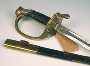 A Second World War period U.S. Marines officer's sword by S.E. Eby Co. Phila., with curved single edged blade, length approx 71cm, etched with 'United States Marines', flag, Marines badge and scrolls, gilt brass hilt, cast with foliate and floral scrolls, wire bound leather covered grip, in its gilt brass mounted leather covered steel scabbard (covering damaged).  Note: a label tied to the hilt states that |This sword was presented to Jack Arkie Williams U.S. Marine pharmacist III class by 5 marine officers in 1944 for saving their lives on Iwa Jima|.