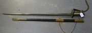 A GRI Royal Indian Navy officer's sword by E. Goldman, Devonport, with straight single edged blade, length approx 78cm, etched with GRI cypher, crowned star above anchor, foliate scrolls, etc, brass hilt with folding guard, lion's head pommel and wire bound sharkskin grip with knot (defective), in its brass bound leather scabbard.