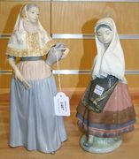 Two Lladro porcelain figures modelled as a Dutch girl with her hands in her headscarf, and a Spanish woman holding a vase and a fan.