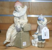 Two Lladro porcelain figures, the first a seated young clown, the second an Eskimo boy accompanied by a polar bear cub.
