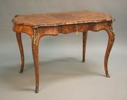 A mid-Victorian burr walnut centre table, the moulded serpentine edge with kingwood crossbanded and boxwood line inlaid decoration, the frieze fitted with a single drawer, raised on cabriole legs with gilt metal foliate mounts, width approx 120cm.
