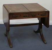 A George IV mahogany sofa table with reeded decoration, the frieze fitted with two short drawers, raised on block supports united by a stretcher, on sabre legs, width approx 148cm (faults).