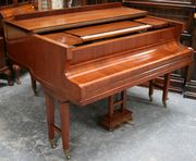 An early 20th Century rosewood cased baby grand piano by 'S. Vickers, Liverpool & Berlin', overstrung, raised on square tapering twin supports with brass caps and castors, length approx 155cm.