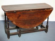 A late 17th/early 18th Century oak gateleg supper table, the oval top above a single frieze drawer, on turned and block legs united by stretchers, width approx 120cm.