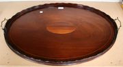 A Victorian mahogany oval tea tray, with line inlaid decoration and applied brass carrying handles.